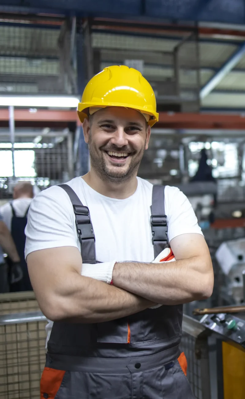 retrato-de-operario-com-os-bracos-cruzados-em-pe-pela-maquina-industrial-na-planta-de-producao